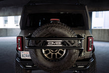 Load image into Gallery viewer, DV8 Offroad 21-23 Ford Bronco Spare Tire Guard &amp; Accessory Mount DV8 Offroad