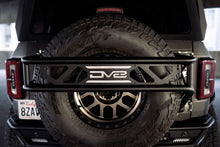 Load image into Gallery viewer, DV8 Offroad 21-23 Ford Bronco Spare Tire Guard &amp; Accessory Mount DV8 Offroad